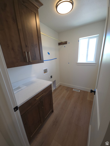 1267 West 2350 South Perry, UT 84302 - Photo 20 of 20 Utility room featuring wood-finish flooring, white walls, and a window for natural light