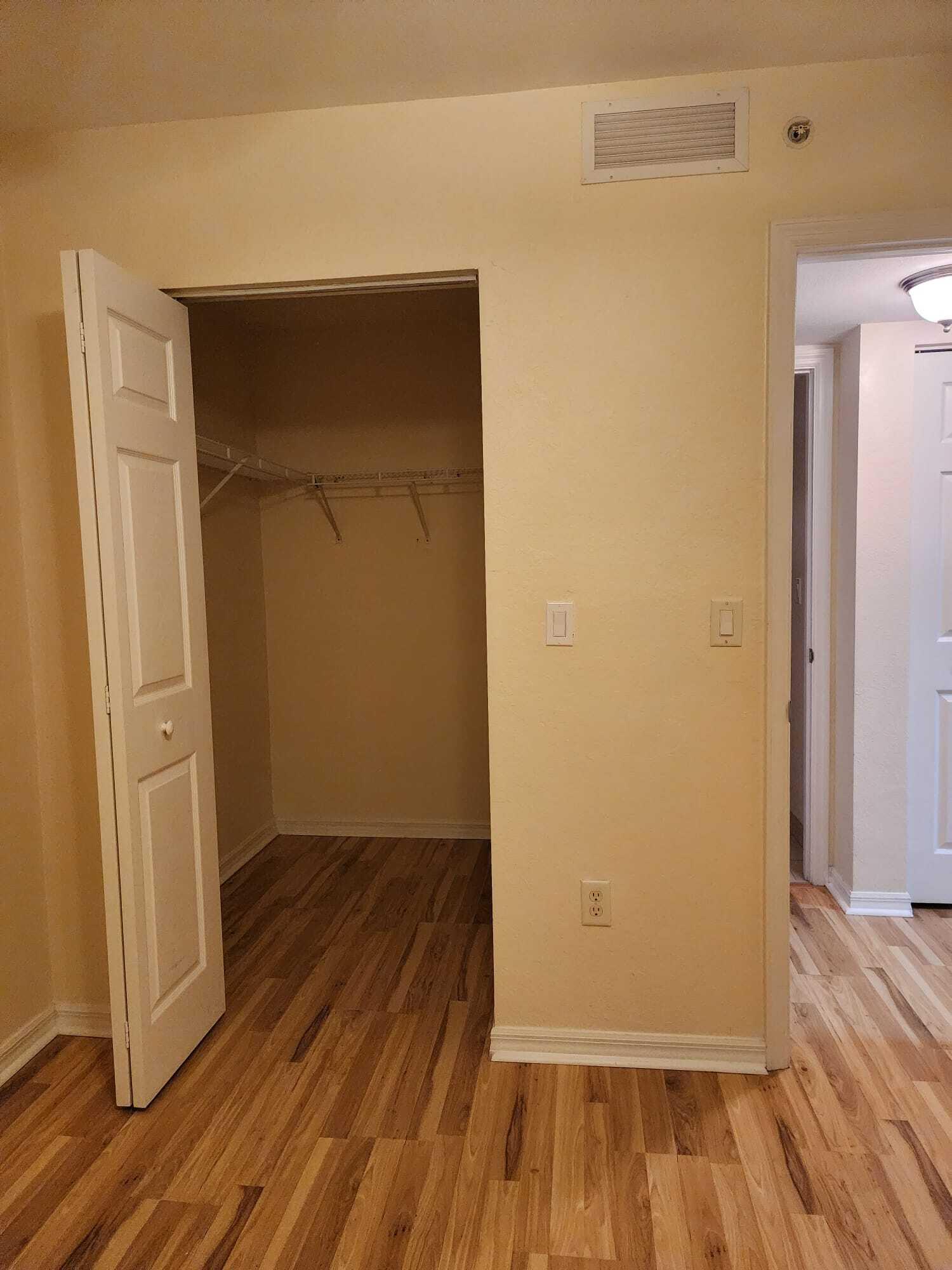 6777 Heritage Grande, Unit 1208 Boynton Beach, FL 33437 - Photo 14 of 17 an empty room with wooden floor and closet