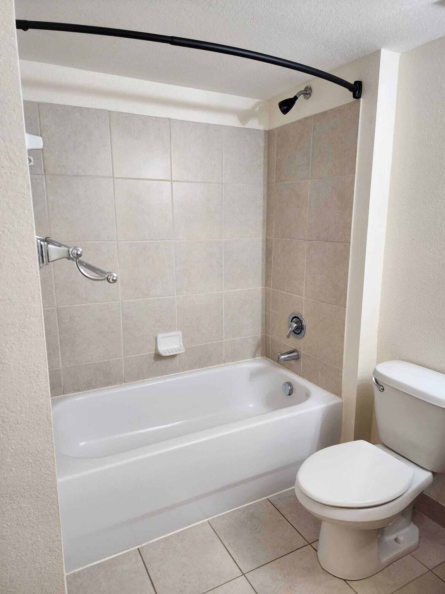 6777 Heritage Grande, Unit 1208 Boynton Beach, FL 33437 - Photo 15 of 17 a bathroom with a toilet and a bath tub
