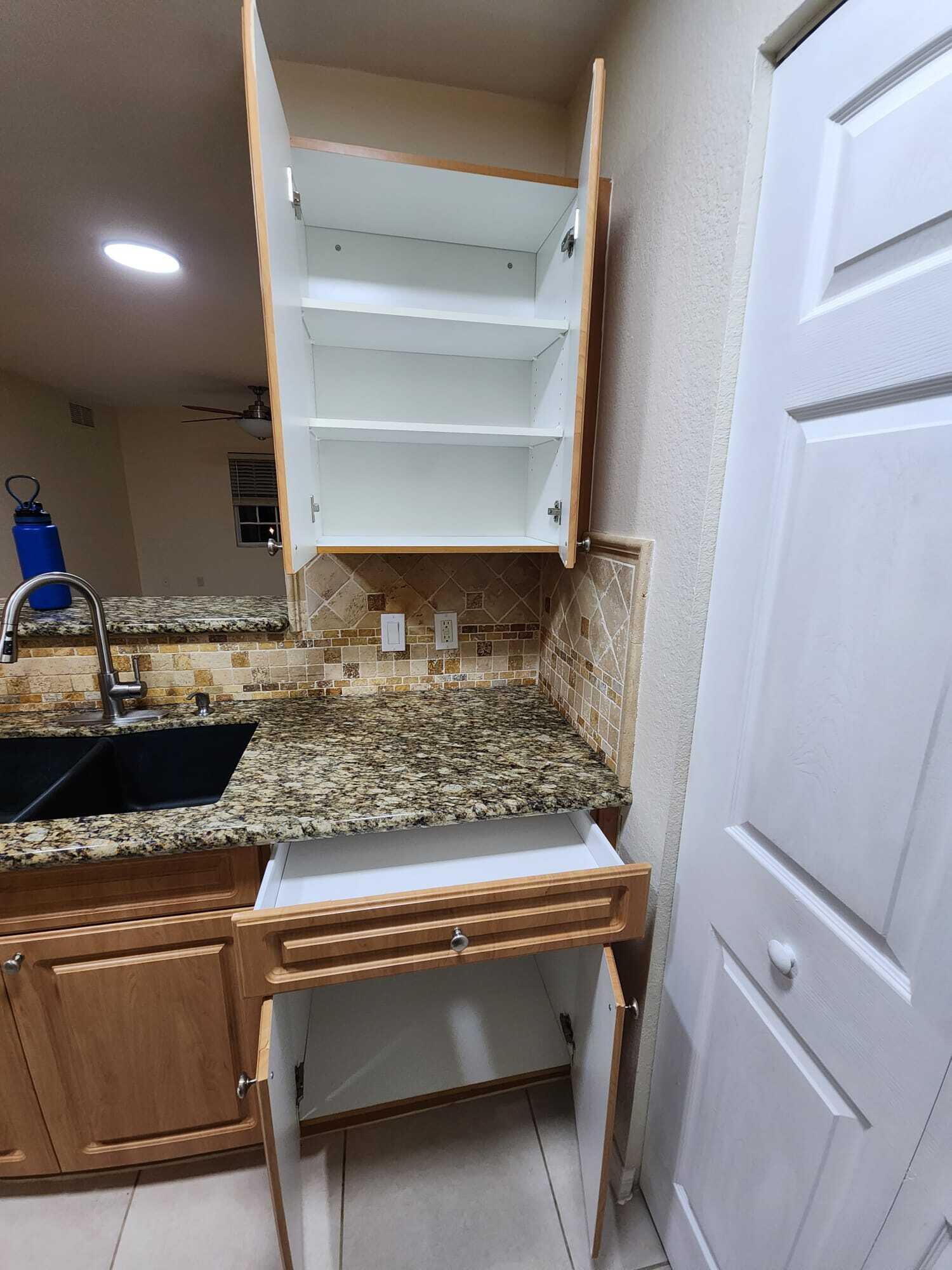 6777 Heritage Grande, Unit 1208 Boynton Beach, FL 33437 - Photo 8 of 17 a bathroom with a sink and a mirror