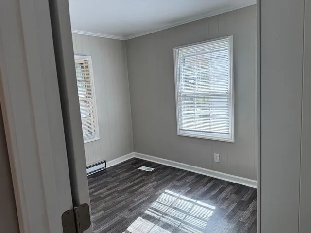 a view of a room with wooden floor and window