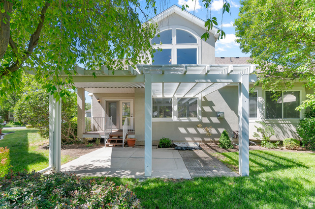1417 Blacksmith Lane Draper, UT 84020 - Photo 43 of 57 Rear exterior featuring a white pergola over a concrete patio and a second-story arched window