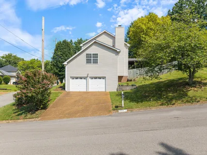 a view of a house with a yard and garage