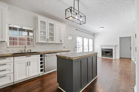 a kitchen with stainless steel appliances granite countertop a stove and cabinets