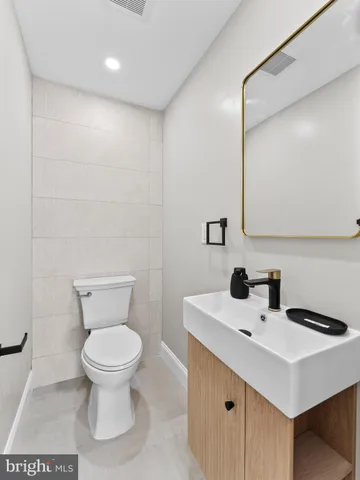 a bedroom with a large bed chandelier and a window