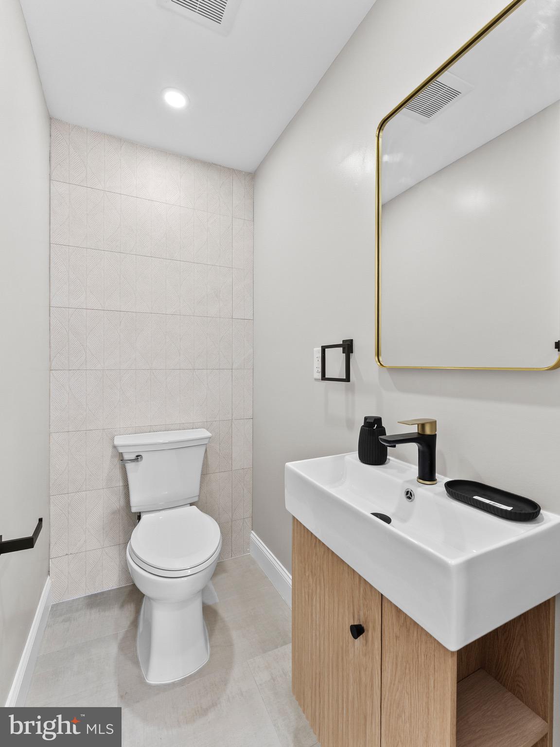 1202 Woodruff Road Glassboro, NJ 08028 - Photo 11 of 28 a bathroom with a sink toilet and a mirror