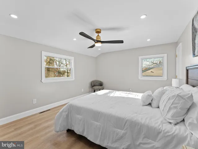 a bedroom with a large bed and a chandelier