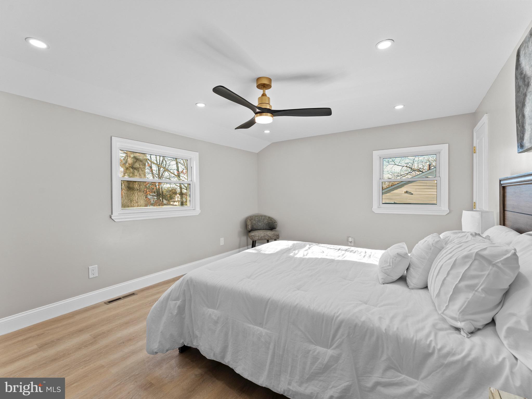 1202 Woodruff Road Glassboro, NJ 08028 - Photo 12 of 28 a bedroom with a large bed chandelier and a window