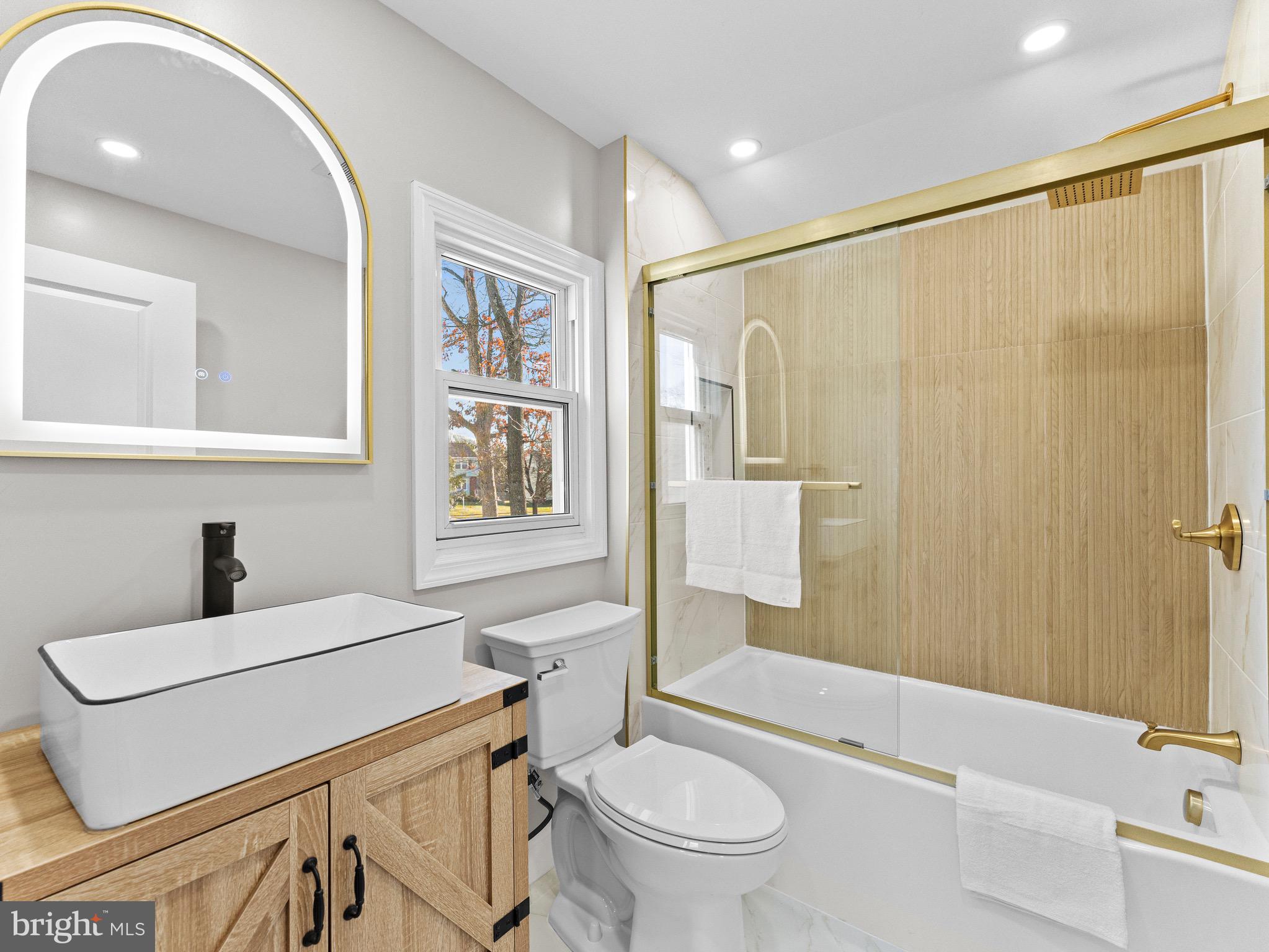 1202 Woodruff Road Glassboro, NJ 08028 - Photo 20 of 28 a bathroom with a sink toilet and shower