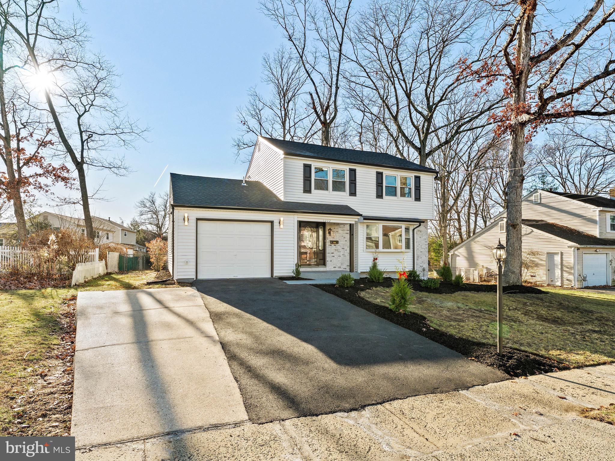 1202 Woodruff Road Glassboro, NJ 08028 - Photo 2 of 28 a front view of a house with a yard and garage