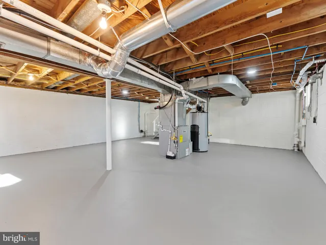 a view of an empty room with a window and a ceiling fan