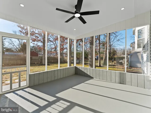 a living room with stainless steel appliances kitchen island granite countertop furniture and a fireplace