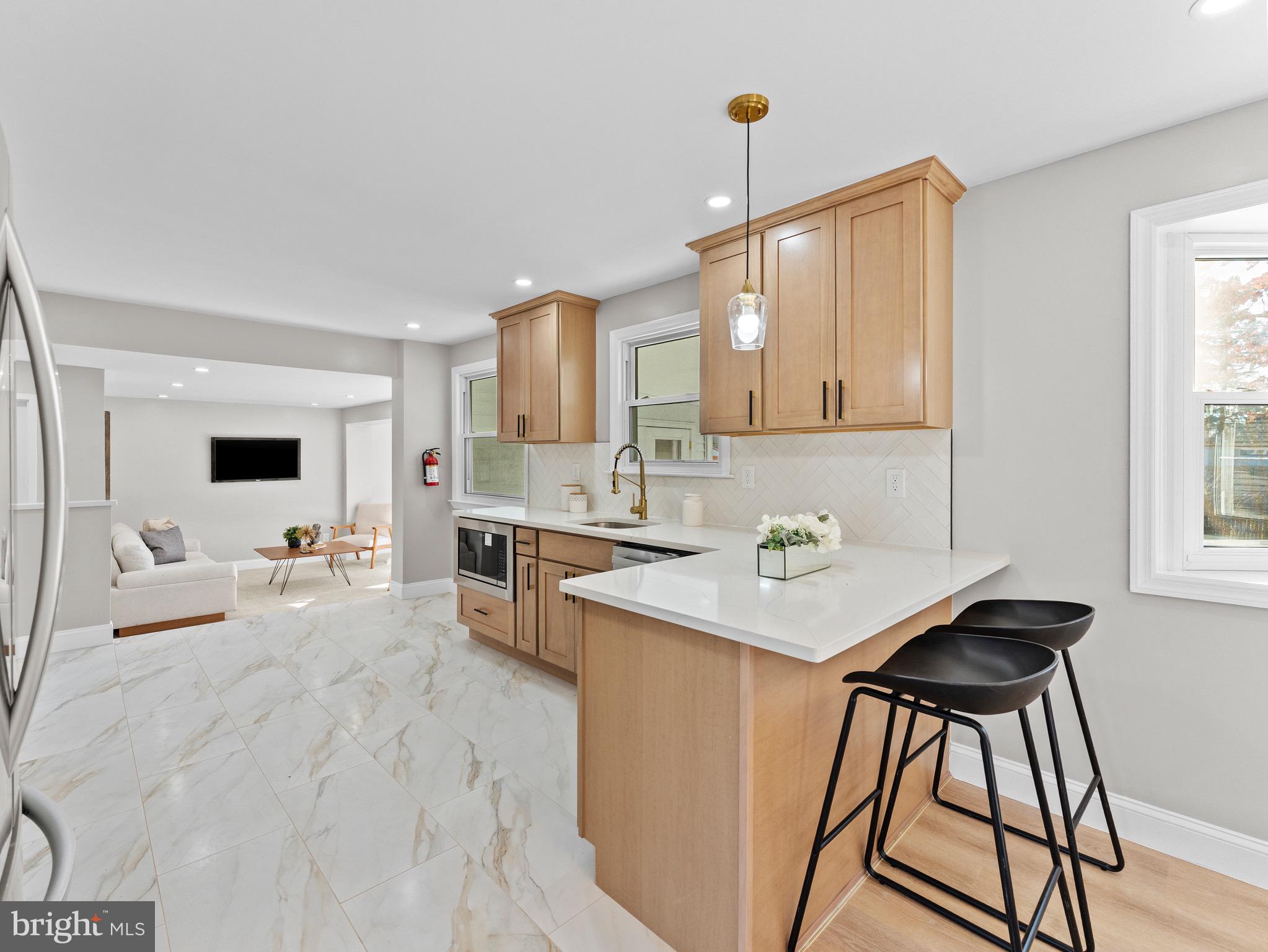 1202 Woodruff Road Glassboro, NJ 08028 - Photo 7 of 28 a kitchen with a sink a stove cabinets and a wooden floor