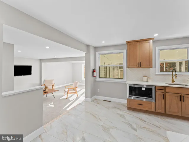 a living room with furniture and floor to ceiling window