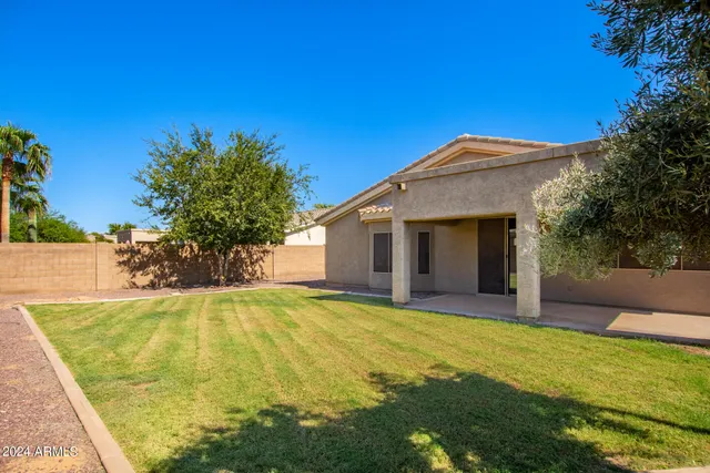 a view of a house with pool and yard