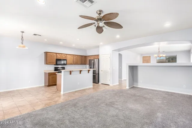 a view of kitchen with cabinets microwave and stove