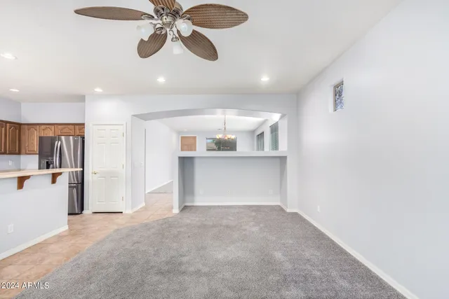 a view of a room with a cabinet and a ceiling fan