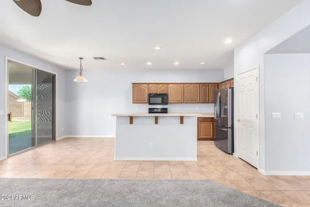 a view of kitchen with stainless steel appliances kitchen island