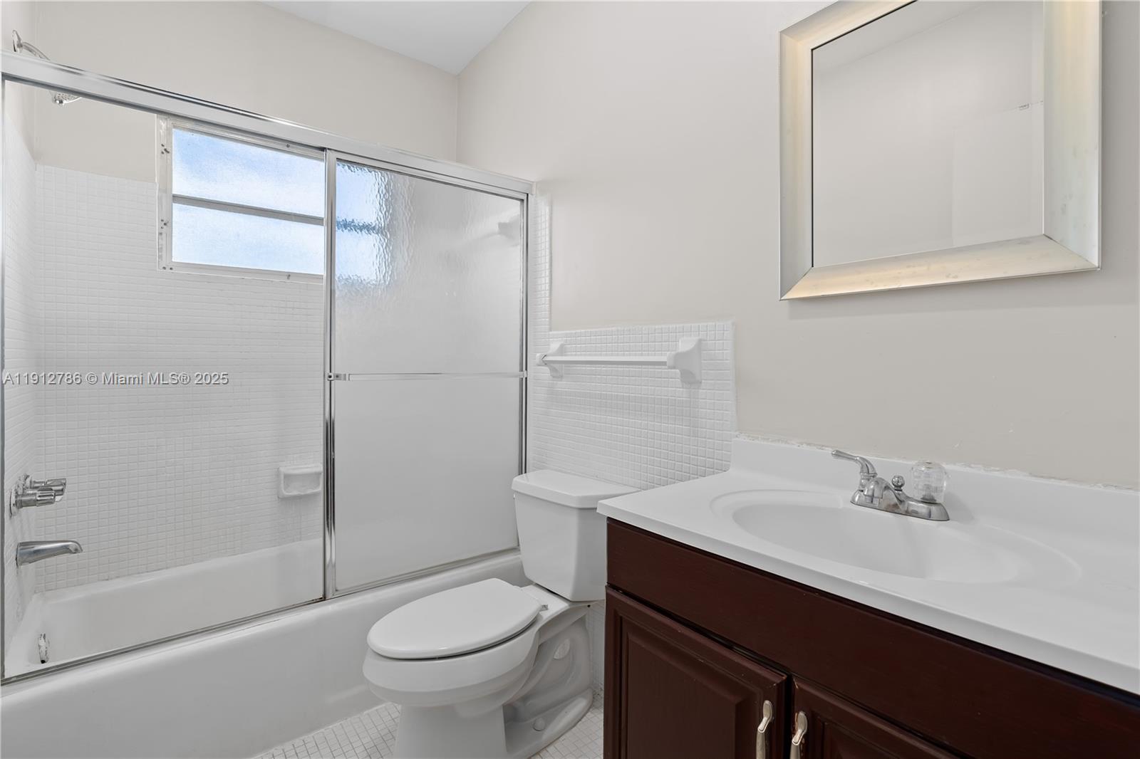 1420 Atlantic Shores Boulevard, Unit 340 Hallandale Beach, FL 33009 - Photo 13 of 33 a bathroom with a sink a toilet and shower