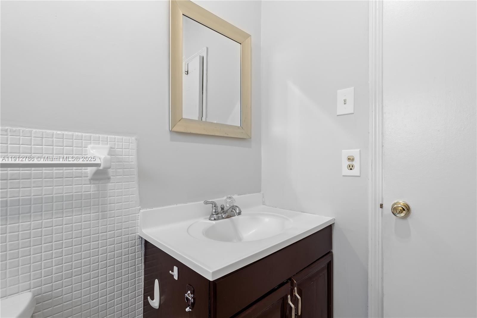 1420 Atlantic Shores Boulevard, Unit 340 Hallandale Beach, FL 33009 - Photo 14 of 33 a bathroom with a sink vanity and a mirror