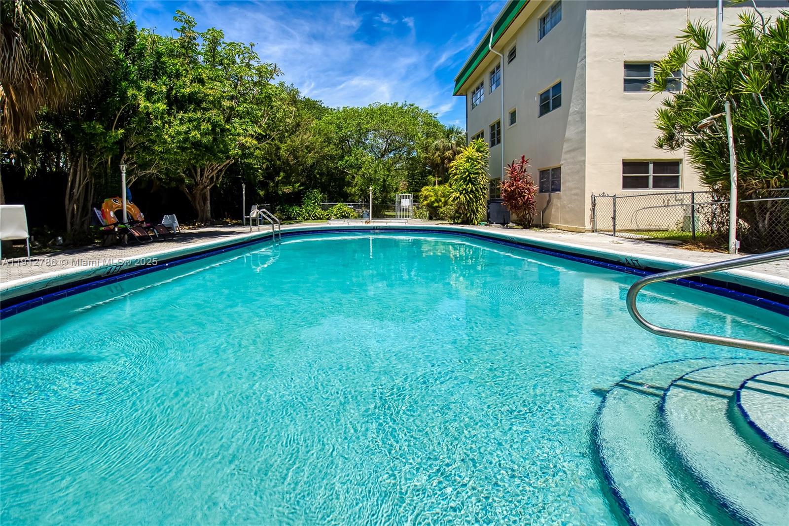1420 Atlantic Shores Boulevard, Unit 340 Hallandale Beach, FL 33009 - Photo 15 of 33 a view of a swimming pool with a patio
