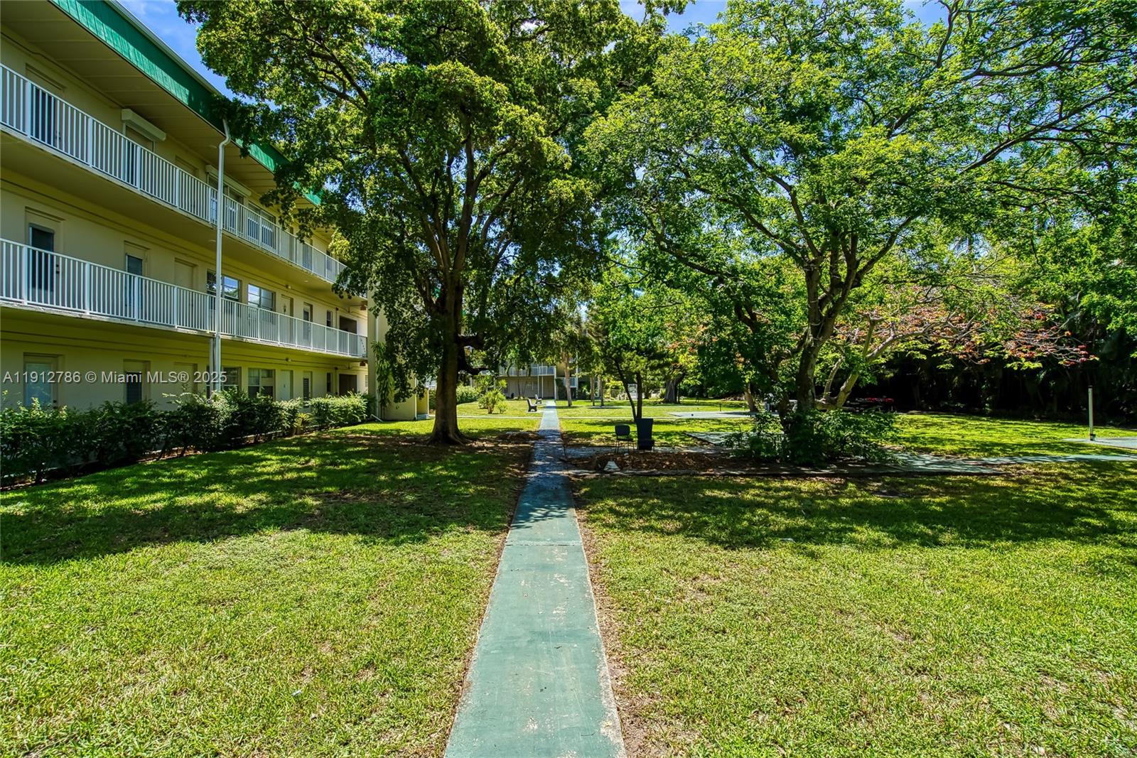 1420 Atlantic Shores Boulevard, Unit 340 Hallandale Beach, FL 33009 - Photo 19 of 33 a view of a yard with plants and trees