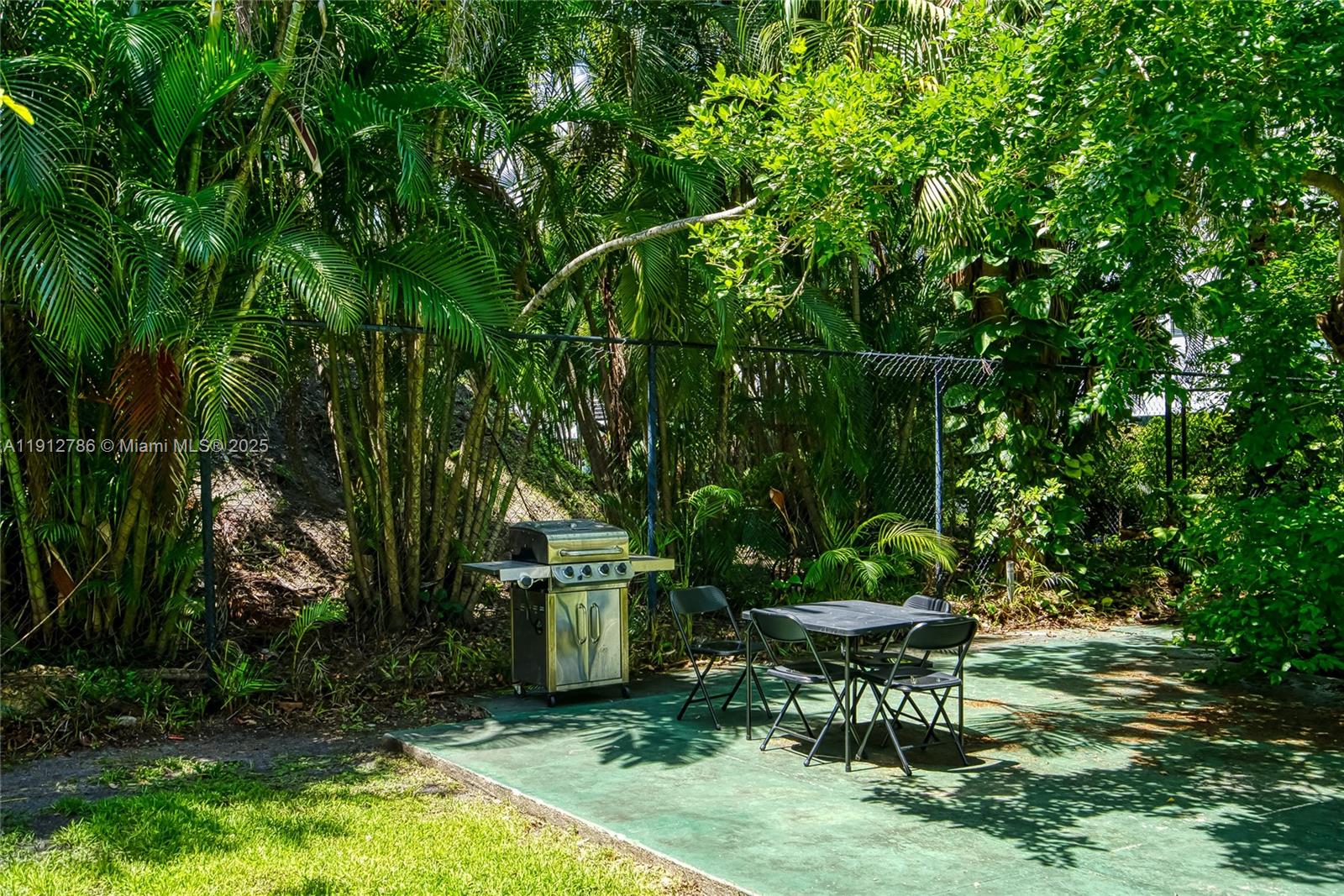 1420 Atlantic Shores Boulevard, Unit 340 Hallandale Beach, FL 33009 - Photo 20 of 33 a view of a chair and table in backyard of the house