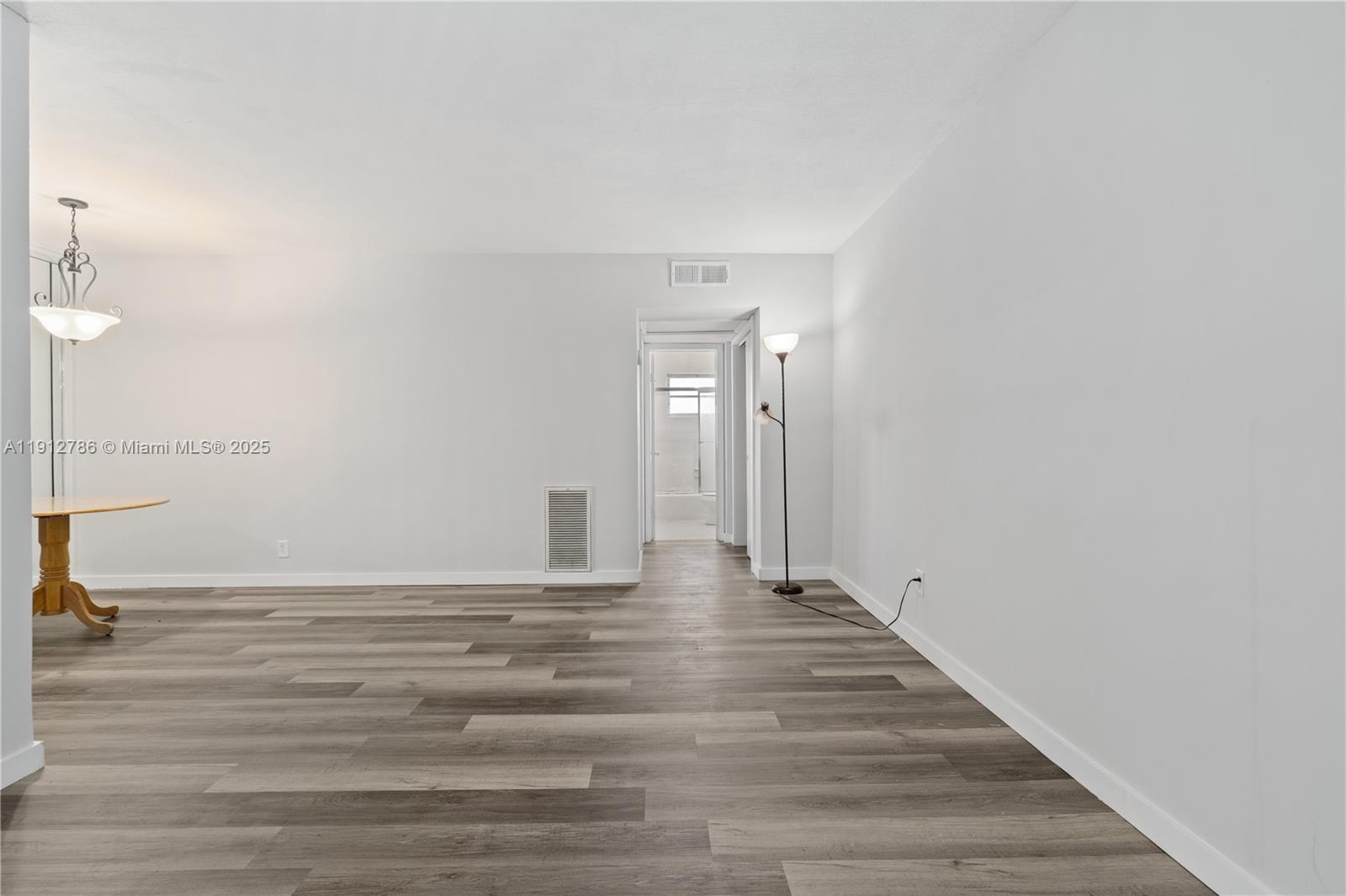 1420 Atlantic Shores Boulevard, Unit 340 Hallandale Beach, FL 33009 - Photo 3 of 33 a view of an empty room with wooden floor