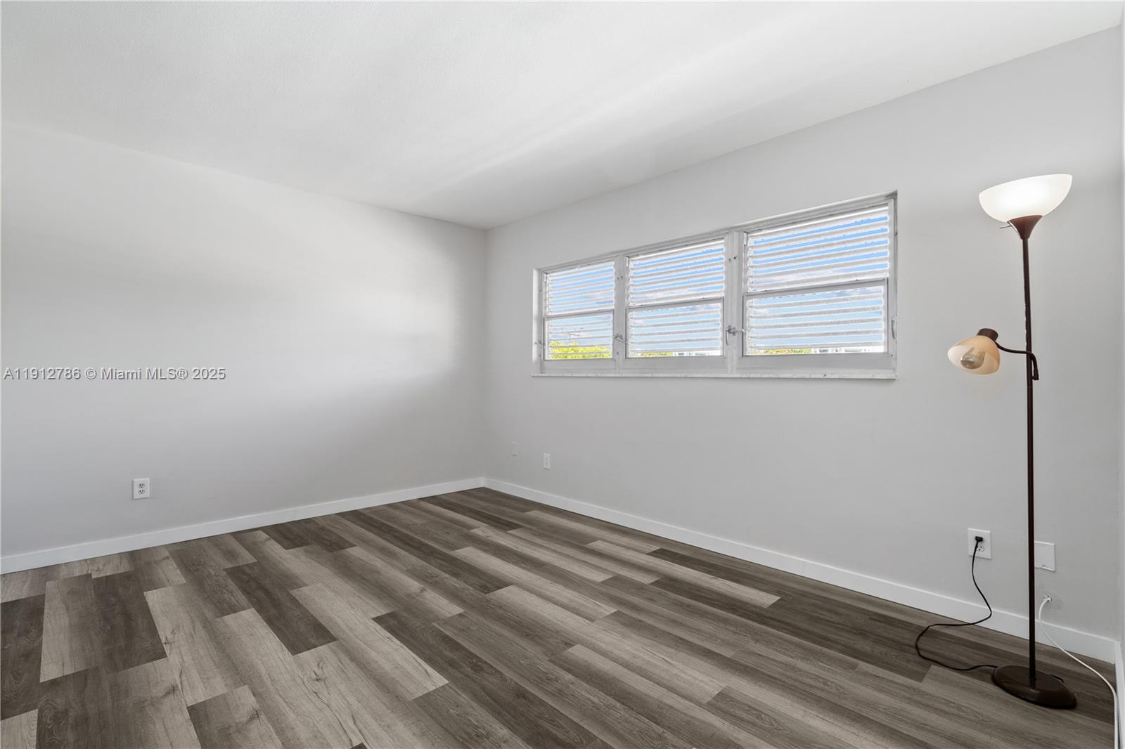 1420 Atlantic Shores Boulevard, Unit 340 Hallandale Beach, FL 33009 - Photo 9 of 33 a view of a room with wooden floor and window