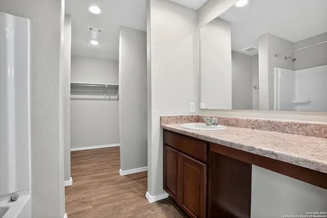 a view of an empty room with wooden floor