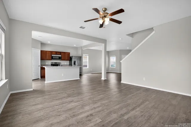 a view of a kitchen with a microwave and a stove top oven