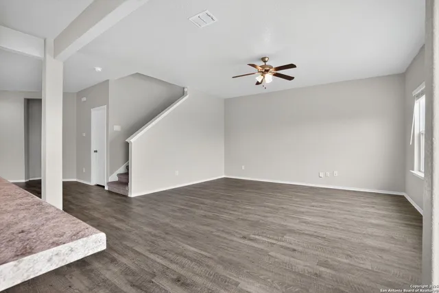 wooden floor in an empty room with a window