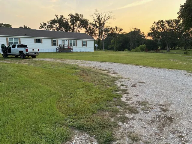 a view of a big yard with a house
