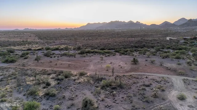 a front view of a house with a yard and a wooden fence