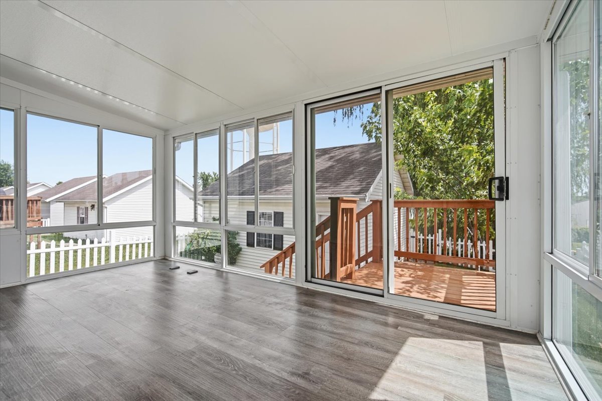 915 Teegan Street Normal, IL 61761 - Photo 11 of 33 an empty room with wooden floor and windows