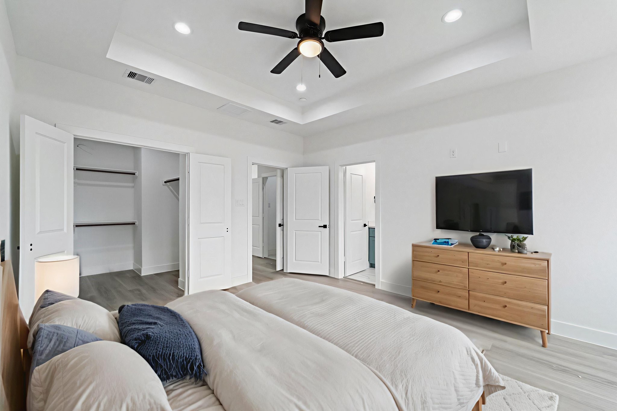 7709 Willow Street Houston, TX 77088 - Photo 11 of 15 This Primary Bedroom features a tray ceiling with recessed lighting. The room includes a wide opening to a walk-in closet and has access to the primary bathroom.