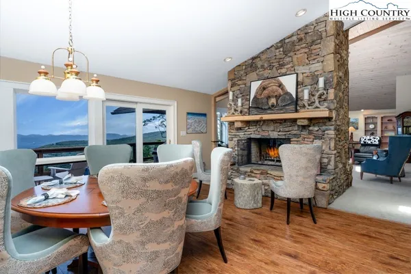 a living room with furniture a fireplace and kitchen view