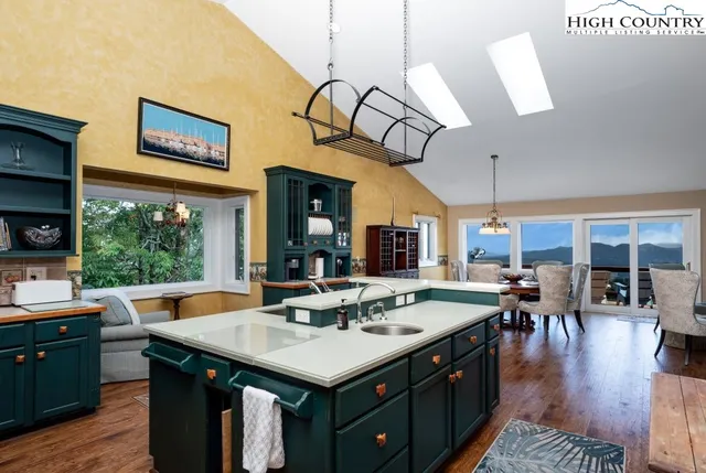 a kitchen with a table chairs and a view of kitchen