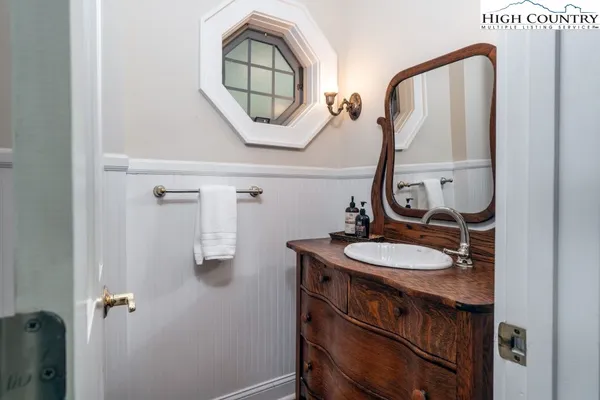 a bathroom with a sink a mirror a vanity and a window