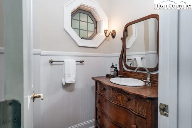 a bathroom with a sink a mirror a vanity and a window
