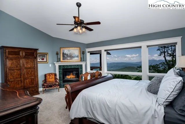 a bedroom with a bed and a fireplace