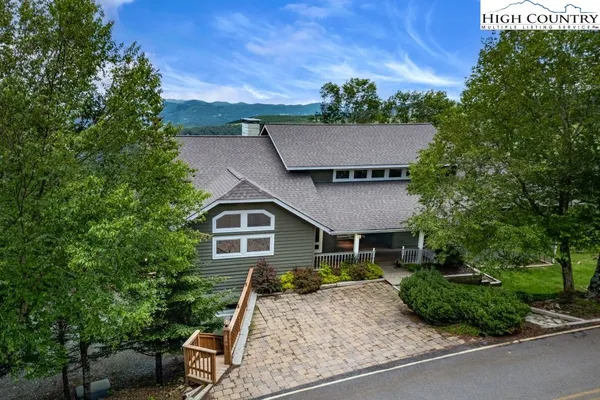 a aerial view of a house with table and chairs in a patio