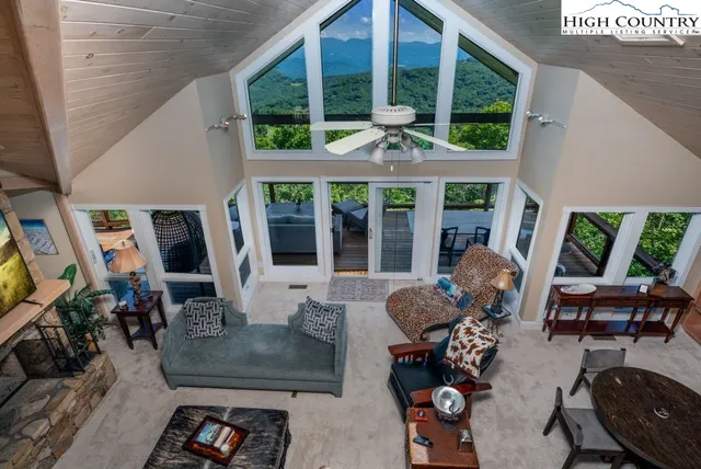 a living room with furniture and large windows