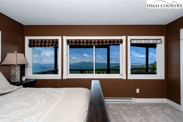 a bedroom with a bed and a large window