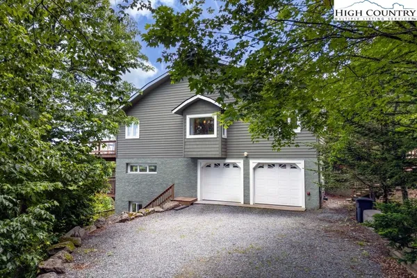 a view of a house with a tree and a yard
