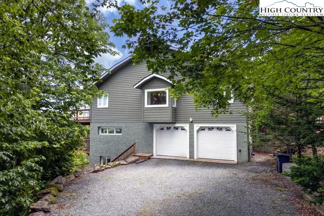 a view of a house with a tree and a yard
