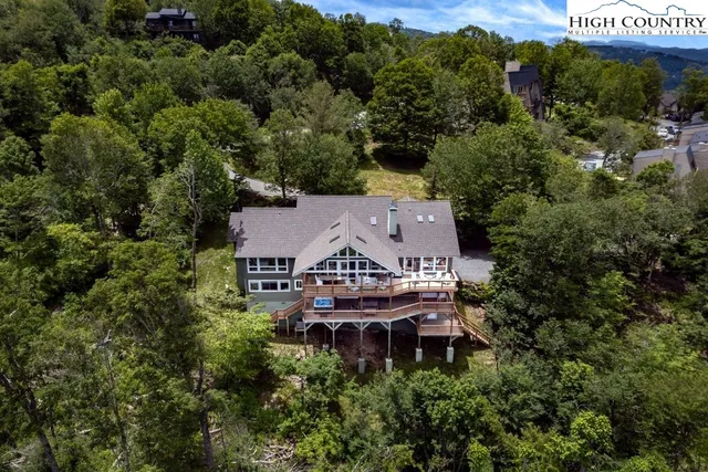 an aerial view of a house with yard and outdoor seating