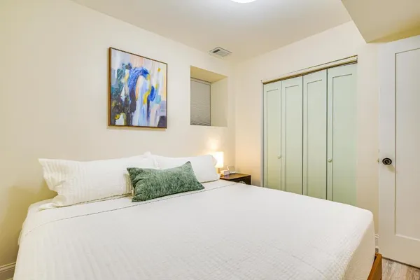 a bedroom with a bed and a flat screen tv