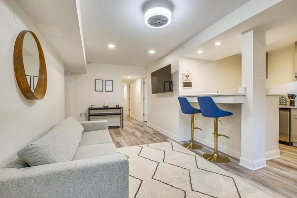 a living room with furniture and a chandelier