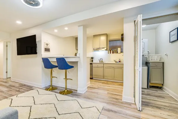 a kitchen with stainless steel appliances kitchen island granite countertop a refrigerator and a stove top oven